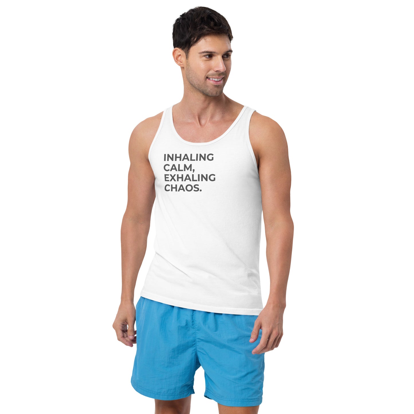 Man wearing an white sleeveless tank with "Inhaling Calm, Exhaling Chaos" text.