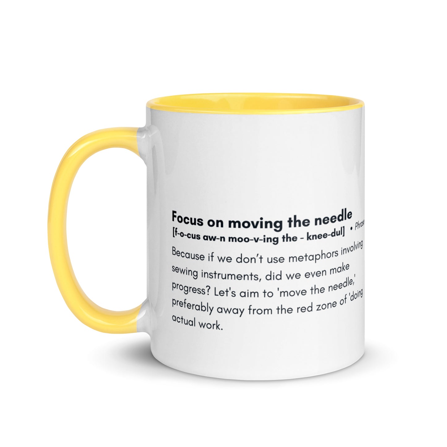 Ceramic white cup with yellow inside and handle with the words, "focus on moving the needle" followed by a humorous definition