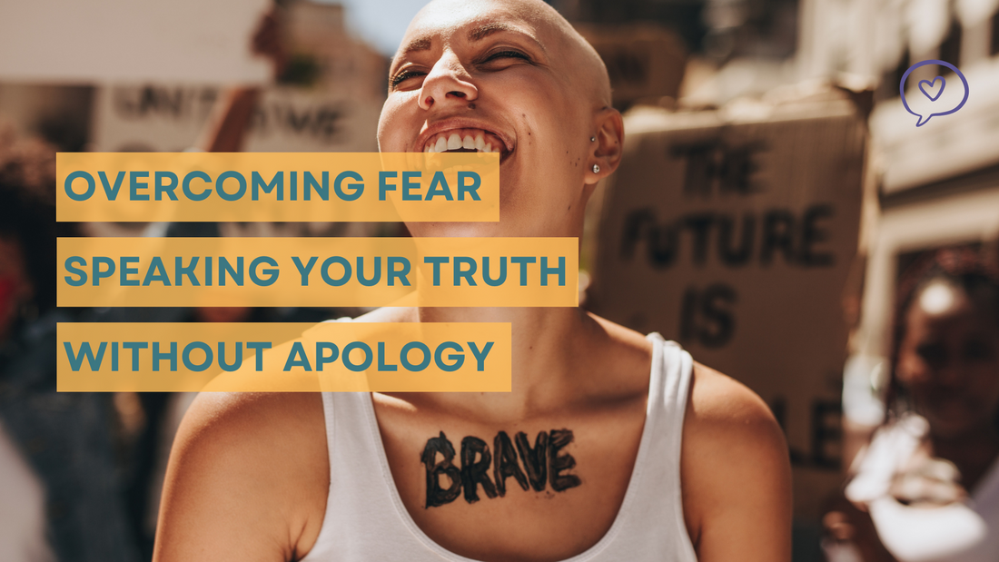 Confident woman smiling with 'BRAVE' tattoo on her chest, standing in a crowd with signs, embodying the message of overcoming fear and speaking her truth without apology.