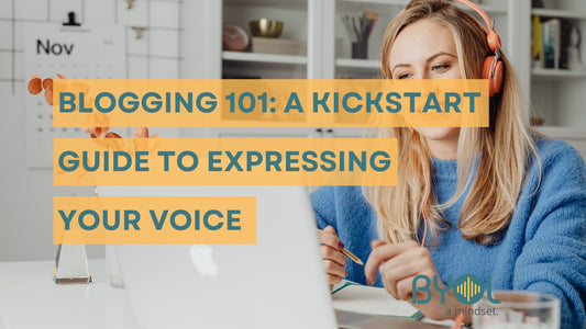 Person with orange headphones writing on a notebook while using a laptop. Text overlay reads 'Blogging 101: A Kickstart Guide to Expressing Your Voice' with BYOL branding.