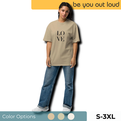 Confident woman modeling a tan oversized tee with bold black "LOVE" print, available in S-3XL, part of Be You Out Loud’s Statement T-Shirts collection.