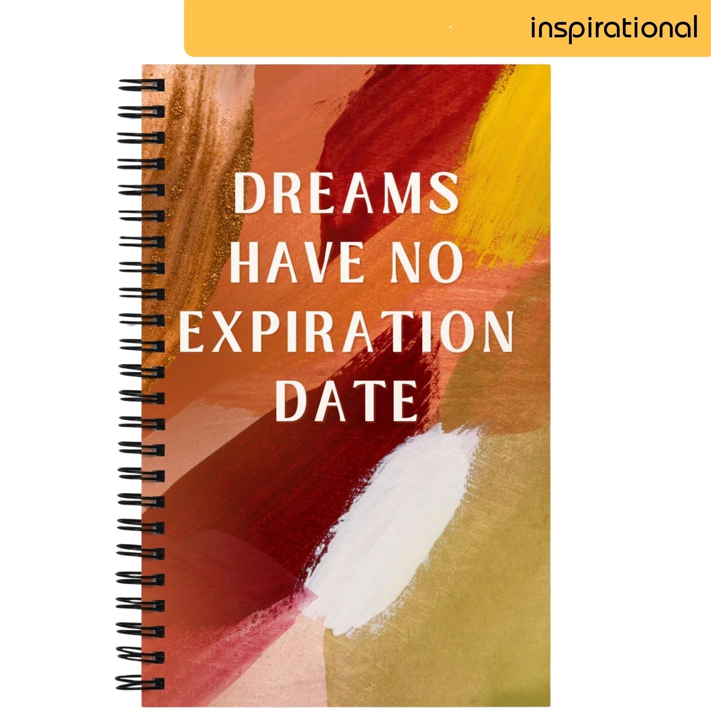 A notepad with a vibrant abstract painting in yellow, orange, red, and white strokes features the uplifting message 'DREAMS HAVE NO EXPIRATION DATE' in bold, capital letters, offering inspiration and a timeless reminder to pursue one's aspirations.