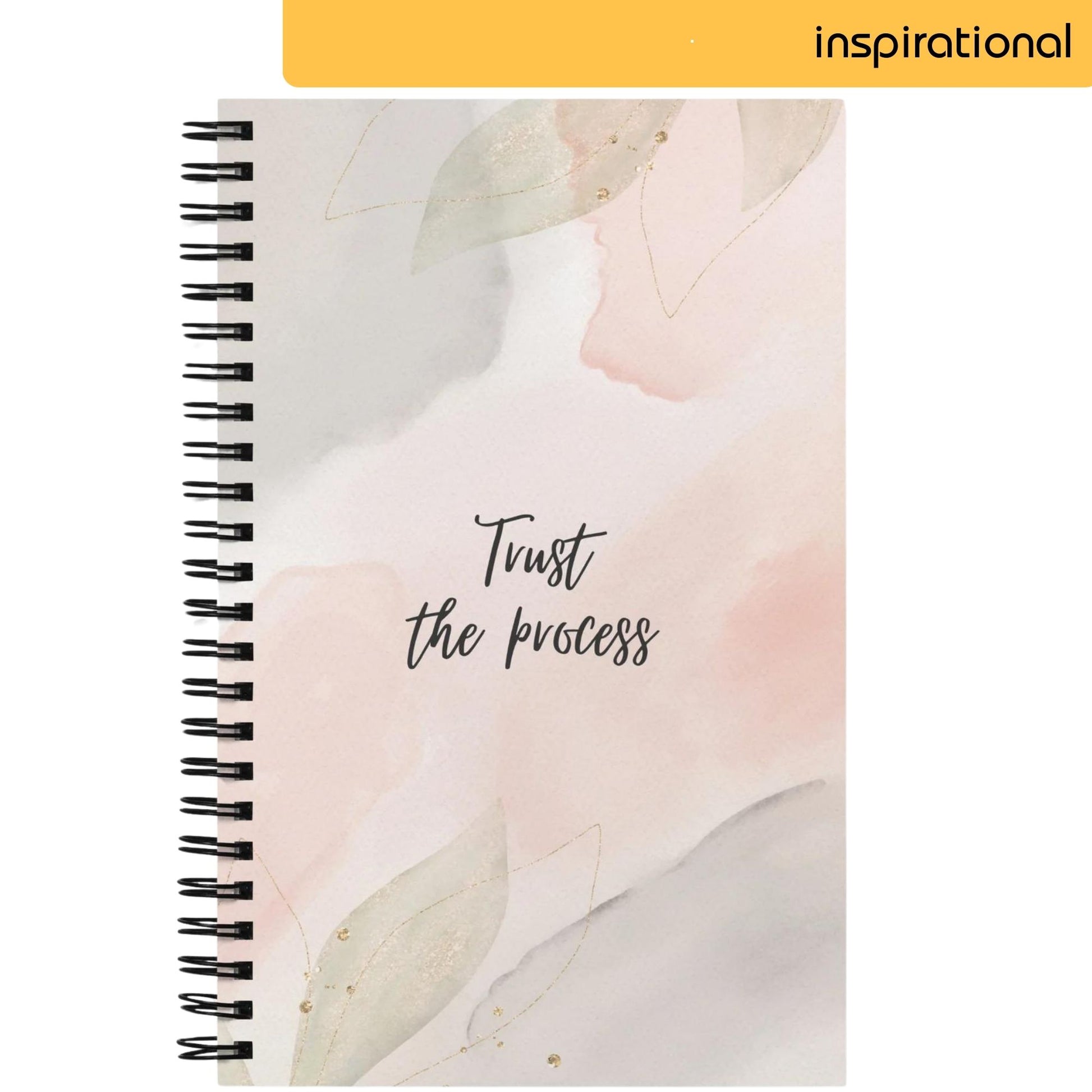 A notepad with a soothing watercolor blend of soft pinks and greys, adorned with delicate golden leaf outlines, features the handwritten message 'Trust the process', offering a serene reminder of patience and faith in one's journey.