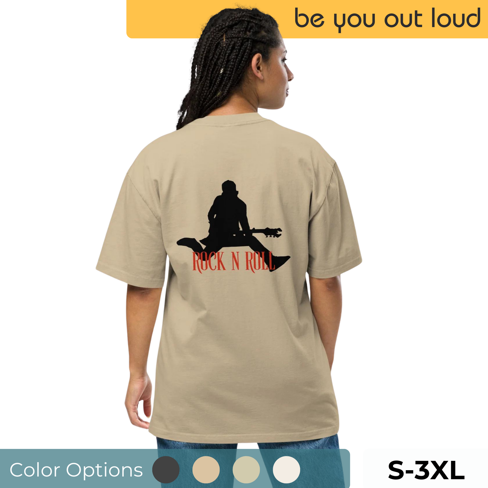 Rear view of a woman wearing a Be You Out Loud khaki oversized tee with a black silhouette of a guitarist and the phrase "ROCK N ROLL" in bold red, reflecting a vintage musical vibe, available in sizes S to 3XL.