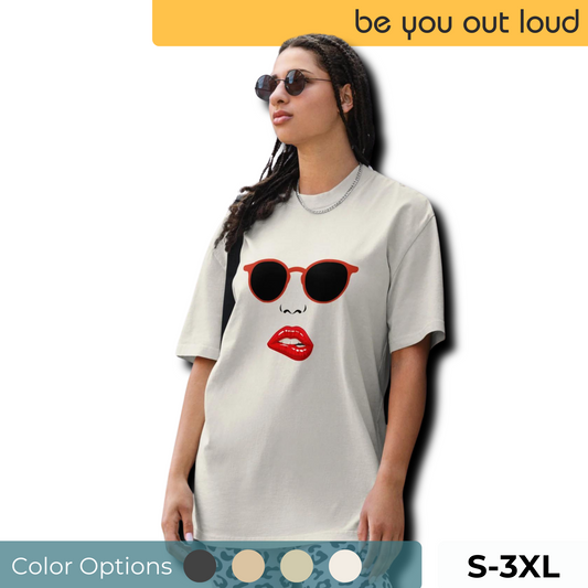 Woman in a casual stance wearing 'Be You Out Loud's' Iconic Red Lips and Sunglasses Oversized Graphic Tee in cream color, available in sizes S to 3XL.