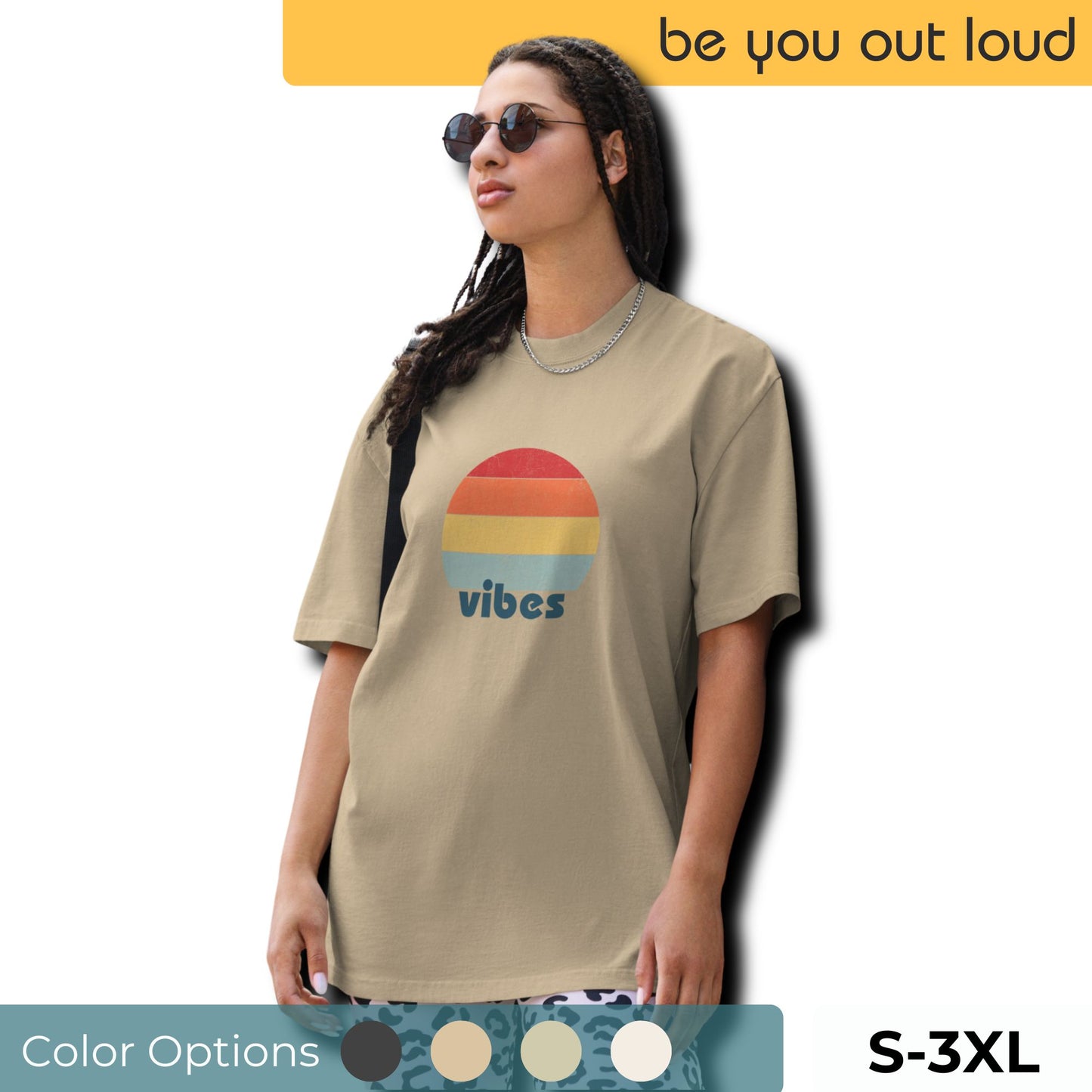 Confident woman showcasing a Women's 'vibes' Oversized Tee with a retro-inspired sunset graphic, radiating laid-back, positive vibes in a neutral color, complemented by chic sunglasses. Available in inclusive sizing from S to 3XL, with a selection of color swatches presented below.