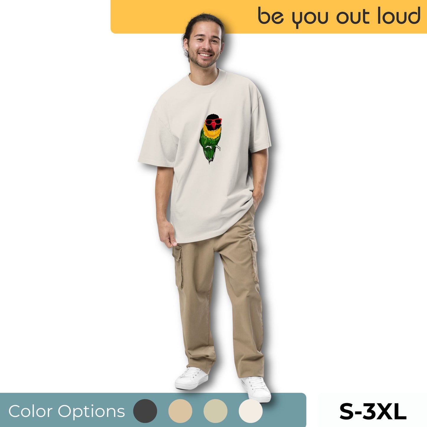 Contented man modeling a sand-colored t-shirt with a vibrant lovebird graphic, combined with matching cargo pants and classic white sneakers. Available in a selection of colors and sizes from small to triple extra-large.