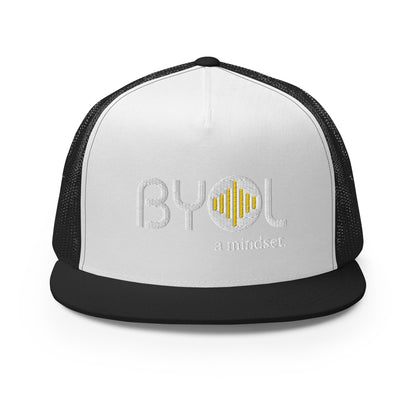 White and black 5-panel trucker hat with "BYOL a mindset" embroidered on the front in white and yellow, displayed against a clean background. Available in various colors: gray, maroon, white and blue, blue, and teal.