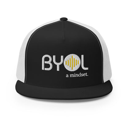 Black and white 5-panel trucker hat with "BYOL a mindset" embroidered on the front in white and yellow, displayed against a clean background. Available in various colors: gray, maroon, white and blue, blue, and teal.