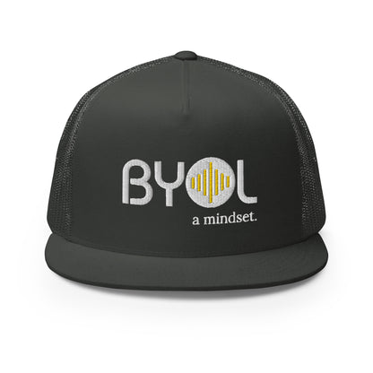 Dark grey 5-panel trucker hat with "BYOL a mindset" embroidered on the front in white and yellow, displayed against a clean background. Available in various colors: gray, maroon, white and blue, blue, and teal.