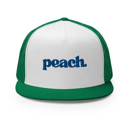 A white and green 5-panel trucker cap with "peach" written in striking blue script across the front, featuring breathable mesh backing and a classic snapback closure.