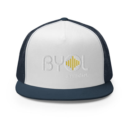 White and navy blue 5-panel trucker hat with "BYOL a mindset" embroidered on the front in white and yellow, displayed against a clean background. Available in various colors: gray, maroon, white and blue, blue, and teal.