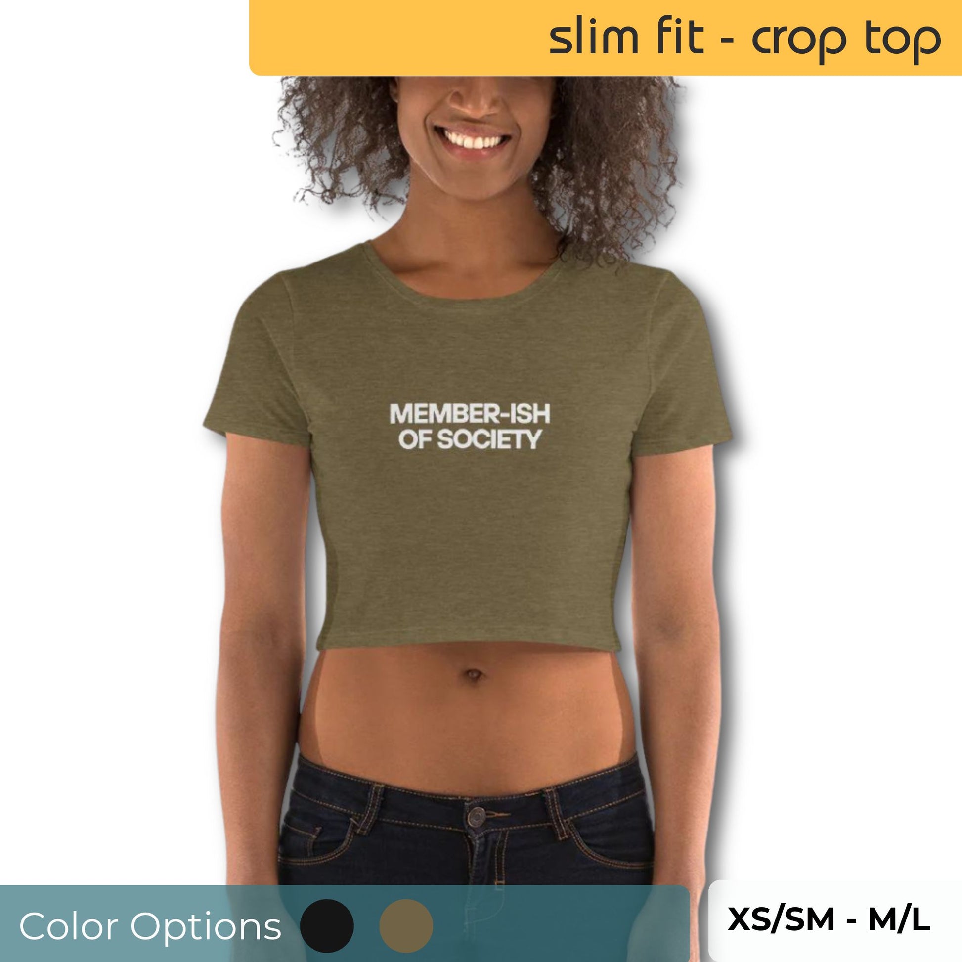 Joyful woman wearing a slim-fit olive crop top with "Member-Ish of Society" in bold white letters, paired with dark jeans, displaying size range XS/SM to M/L and color options.