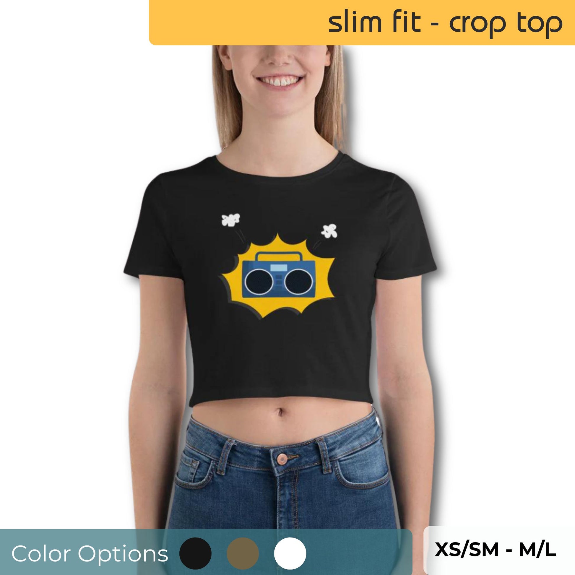 Smiling young woman wearing a black slim fit crop top with a yellow retro boombox graphic and white floral accents, available in XS/SM to M/L, with color options indicated below.