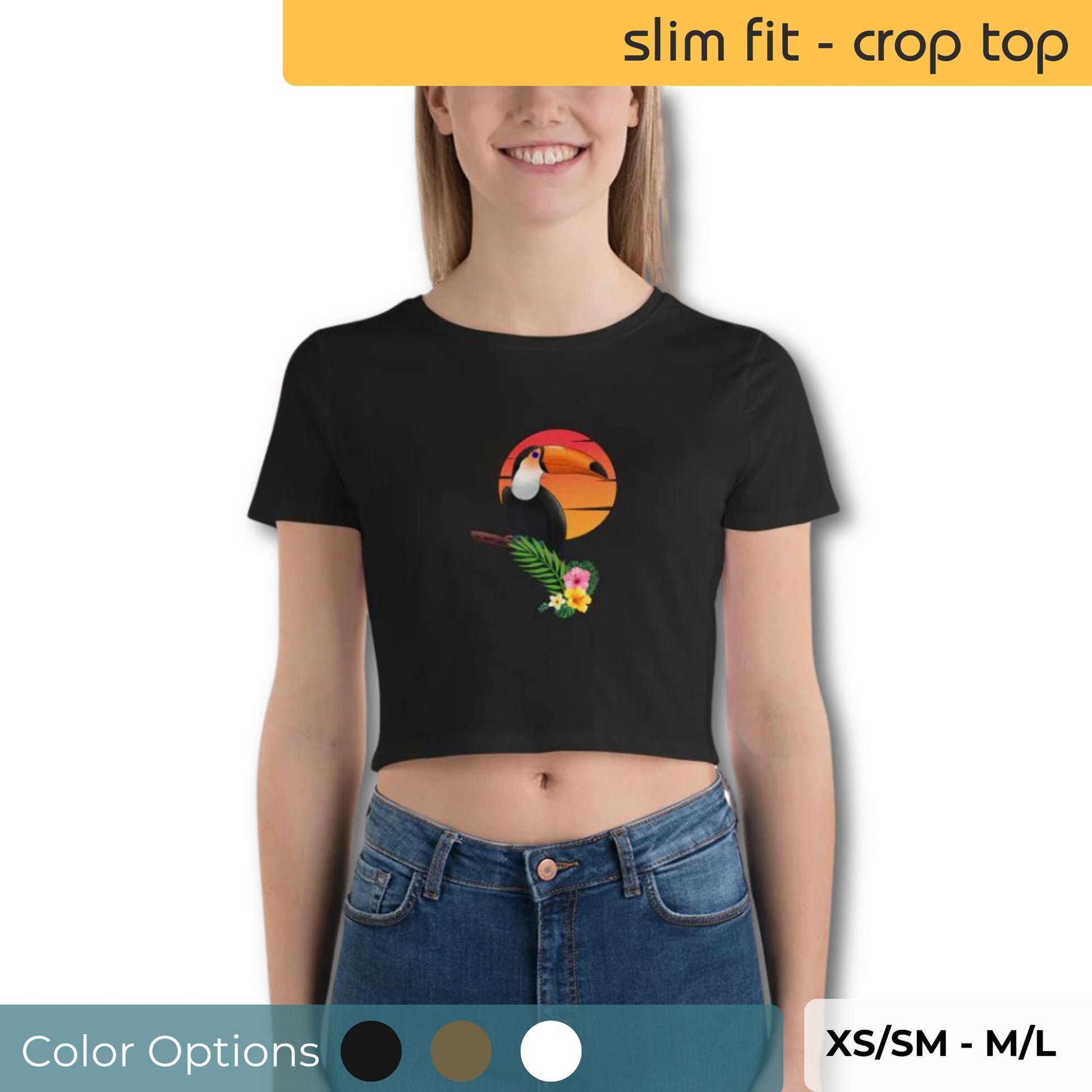 Smiling woman wearing a slim-fit black crop top with a vibrant toucan graphic design, available in multiple colors and sizes XS/SM to M/L.