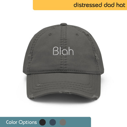 Front view of a gray distressed dad hat with the word 'Blah' embroidered in white, shown with color options below.