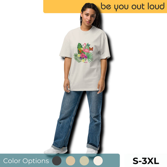 Woman showcasing a white tropical print T-shirt featuring a colorful parrot and lush foliage, part of the 'Be You Out Loud' collection, available in sizes S through 3XL, with a visual guide to color options, styled with classic blue denim and white sneakers.