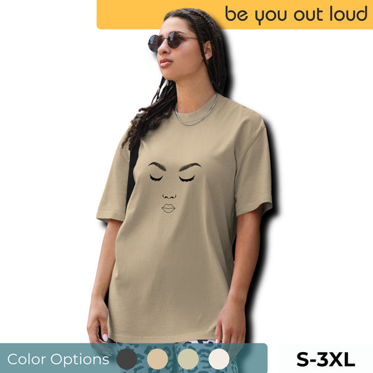 Woman in a chic, minimalist 'Artistic Expression' faded black Oversized Tee, adorned with a stylized facial outline, exuding a love for simplicity and art, with diverse color options and sizes S-3XL available.