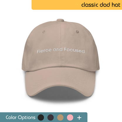 Front view of a beige classic dad hat with 'Fierce and Focused' embroidered in white, featuring a color selection palette for customization options.