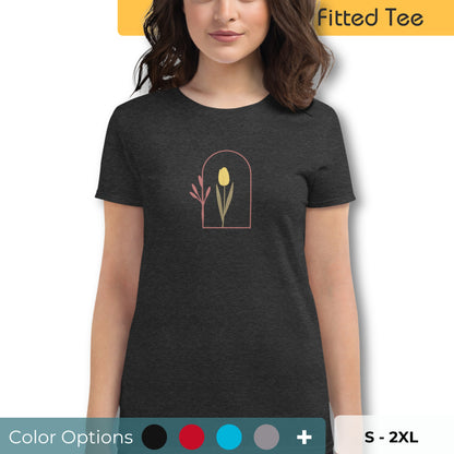 Woman wearing a black fitted tee with a delicate tulip arch design, showcasing subtle elegance and nature-inspired style by BYOL. Showing that there are multiple color and size options