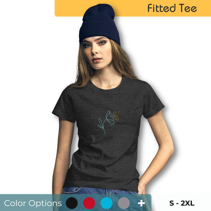 Woman wearing a dark grey fitted tee with a delicate flower design in blue and yellow, embodying subtle self-expression and style by BYOL. Sowing that there are multiple color and size options