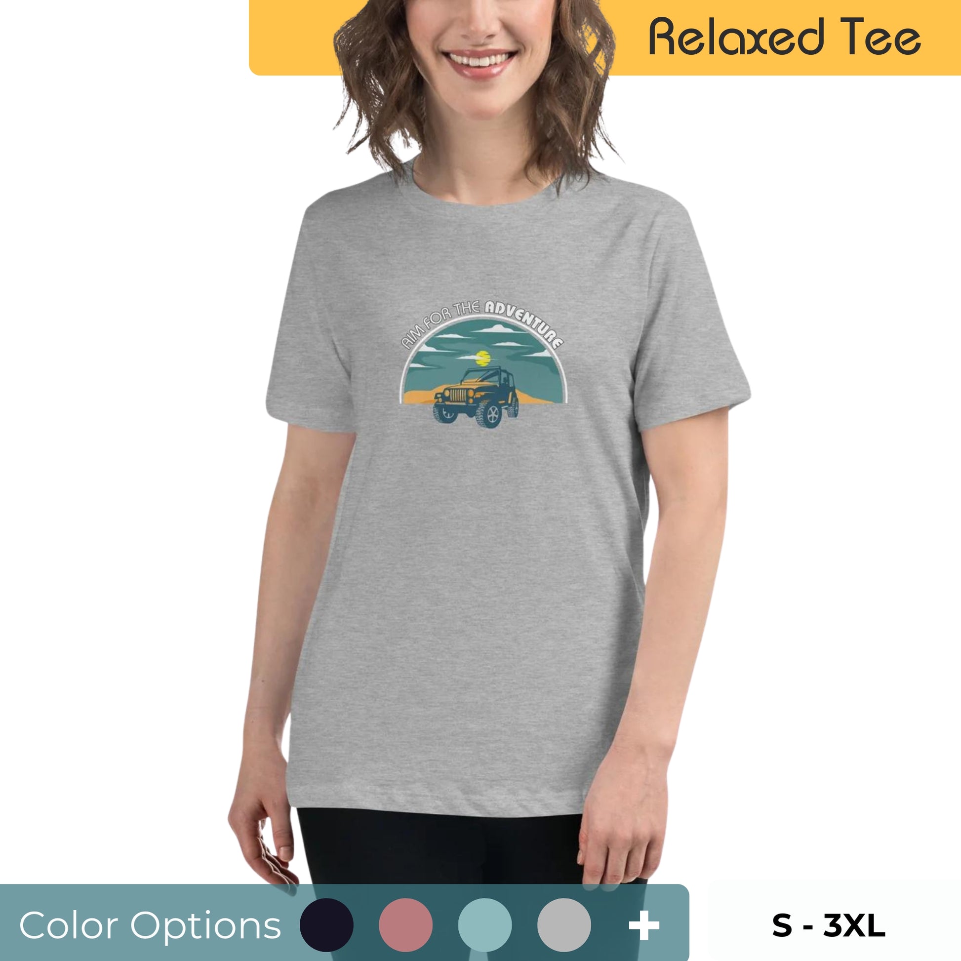 Smiling woman with wavy hair wearing a grey relaxed tee featuring a graphic of a green off-road vehicle under a 'Time for the Adventure' arc, available in multiple colors, sizes S-3XL