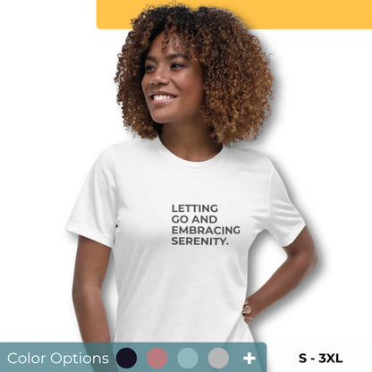 Woman wearing a white relaxed tee with "Letting Go and Embracing Serenity" printed, available in various colors and sizes from S-3XL.