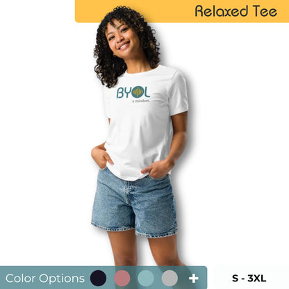 Woman wearing a relaxed fit BYOL mindset t-shirt in white with color options in black, pink, blue, and gray, available in sizes S to 3XL.