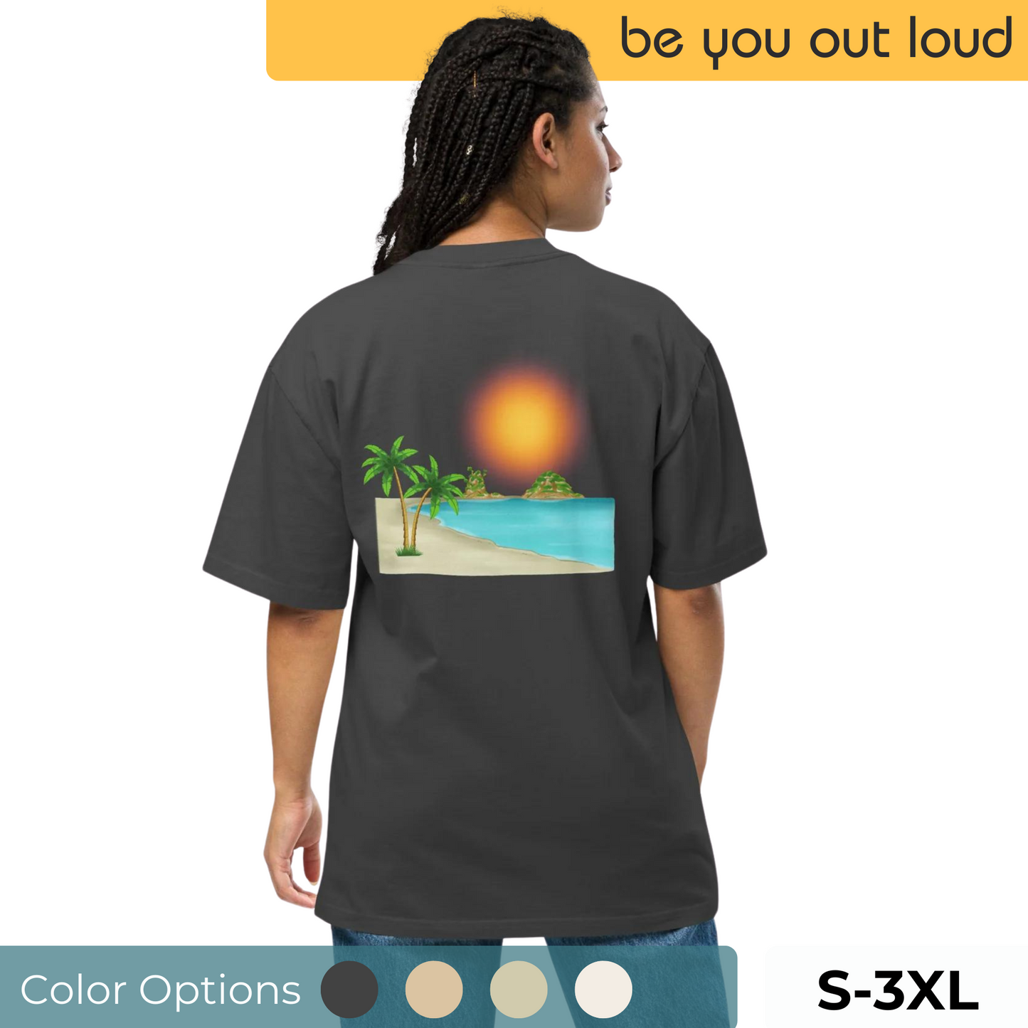 Woman in a faded black oversized T-shirt with a vibrant beach sunset graphic, available in sizes S to 3XL, suggesting a relaxed tropical vibe, paired with comfortable blue jeans, perfect for summer wear or vacation fashion.