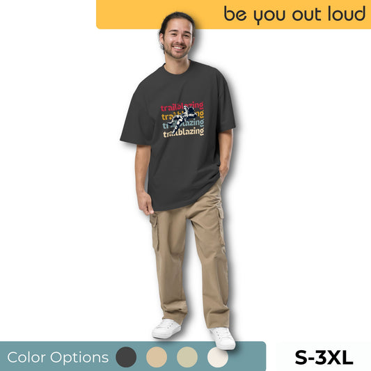 Man smiling wearing Be You Out Loud's Trailblazing Spirit Bold Graphic Oversized Tee in black, available in sizes S to 3XL, with color options shown.