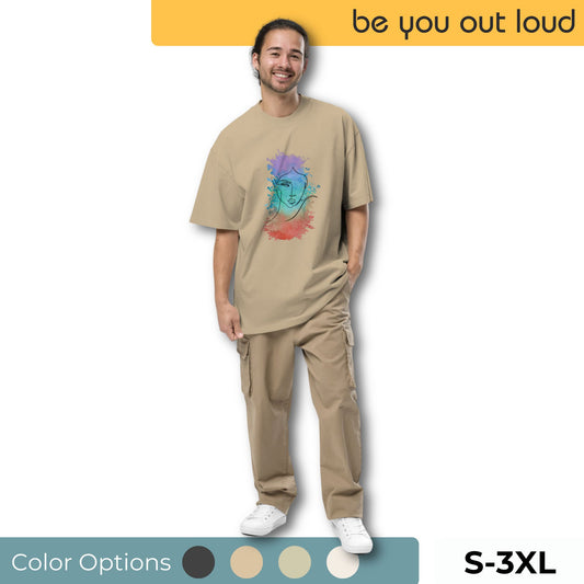 Happy man wearing Be You Out Loud Men's "Mindful Expression" Artistic Oversized Graphic Tee in a neutral shade, available in sizes S-3XL with color options, featuring a colorful abstract face design for a unique fashion statement.