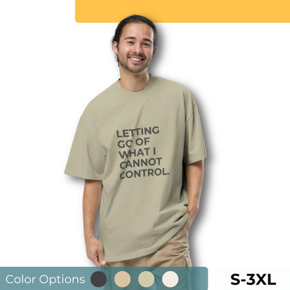 Man wearing an oversized faded tee in light beige with "Letting Go of What I Cannot Control" text. Available in multiple colors and sizes S-3XL.