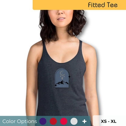 Woman wearing a heather navy racer back tank top with a subtle design of a crescent moon over mountains.