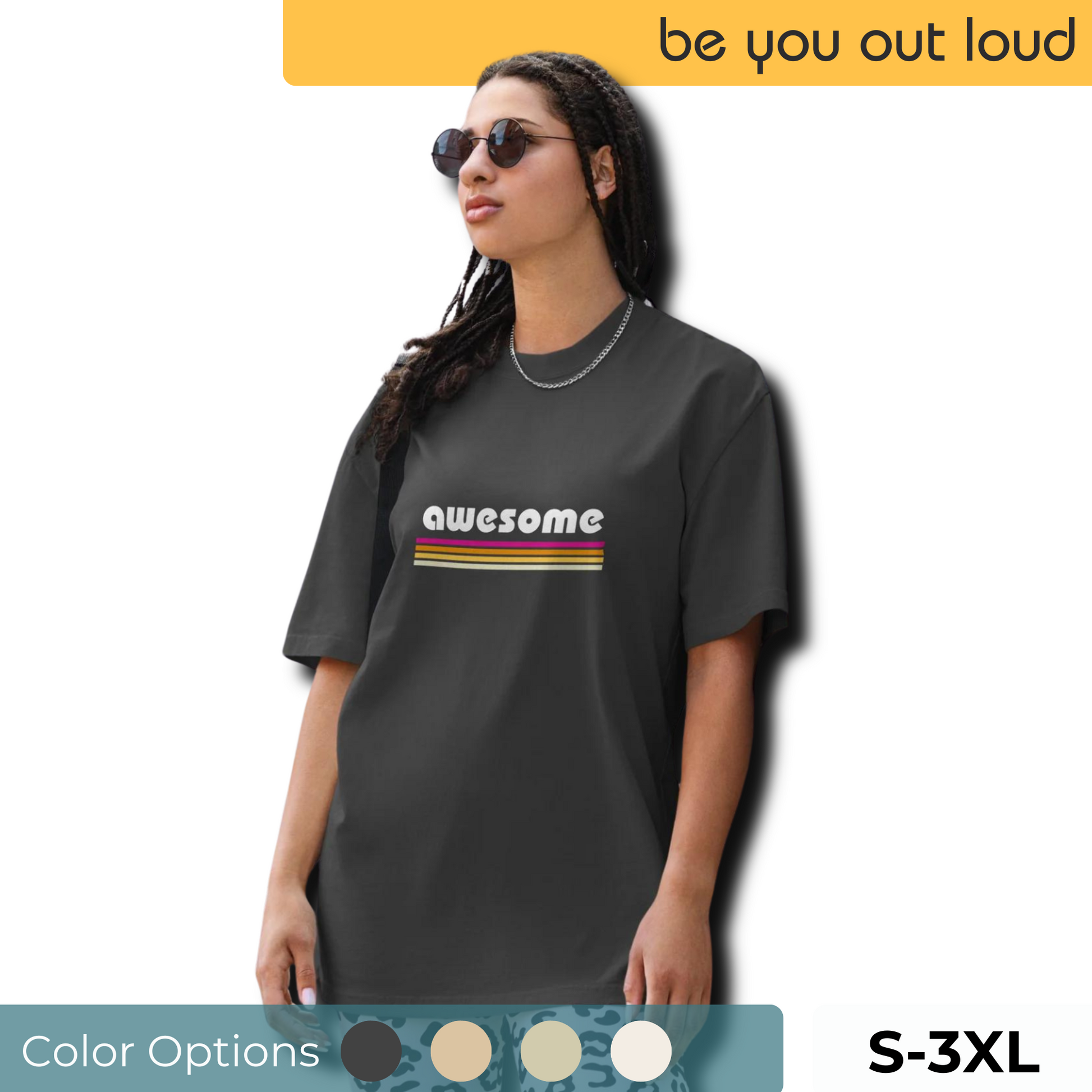 A trendy woman sports a Women's Retro 'AWESOME'  faded black Oversized Tee , paired with playful patterned pants and accessorized with sunglasses, reflecting a cool, vintage vibe. Tee available from S-3XL.