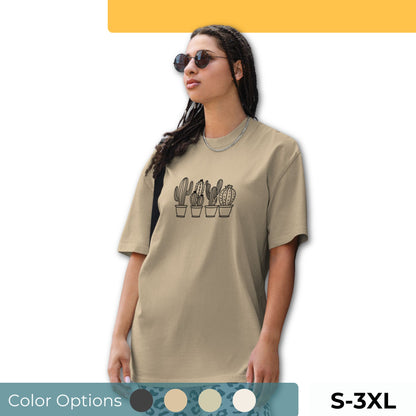 Woman wearing an oversized faded tee with a charming cactus design, showcasing unique self-expression and quirky elegance, available in multiple colors and sizes S-3XL.