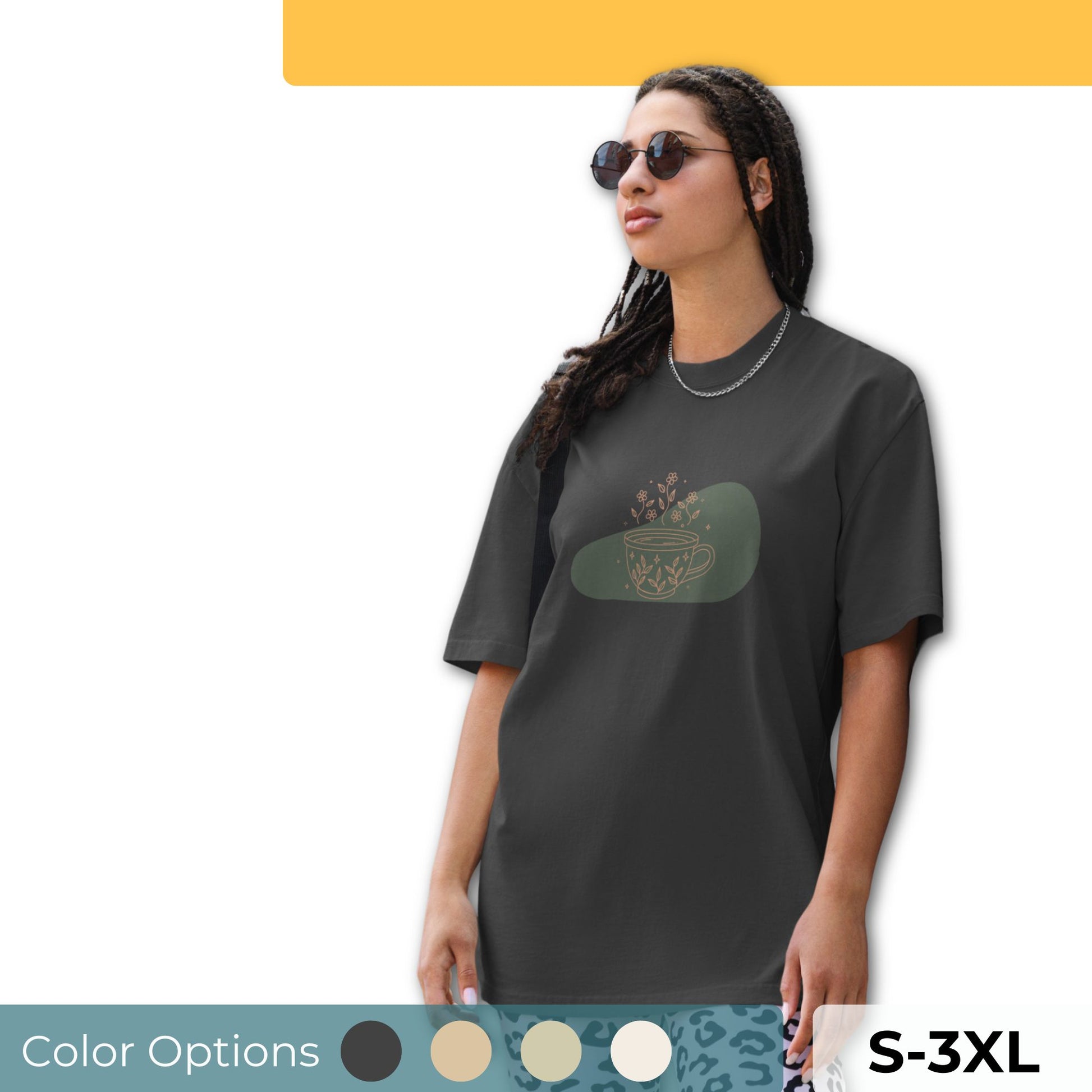 Woman wearing an oversized faded tee with a whimsical tea cup design, highlighting playful self-expression and bold fashion, available in multiple colors and sizes S-3XL.