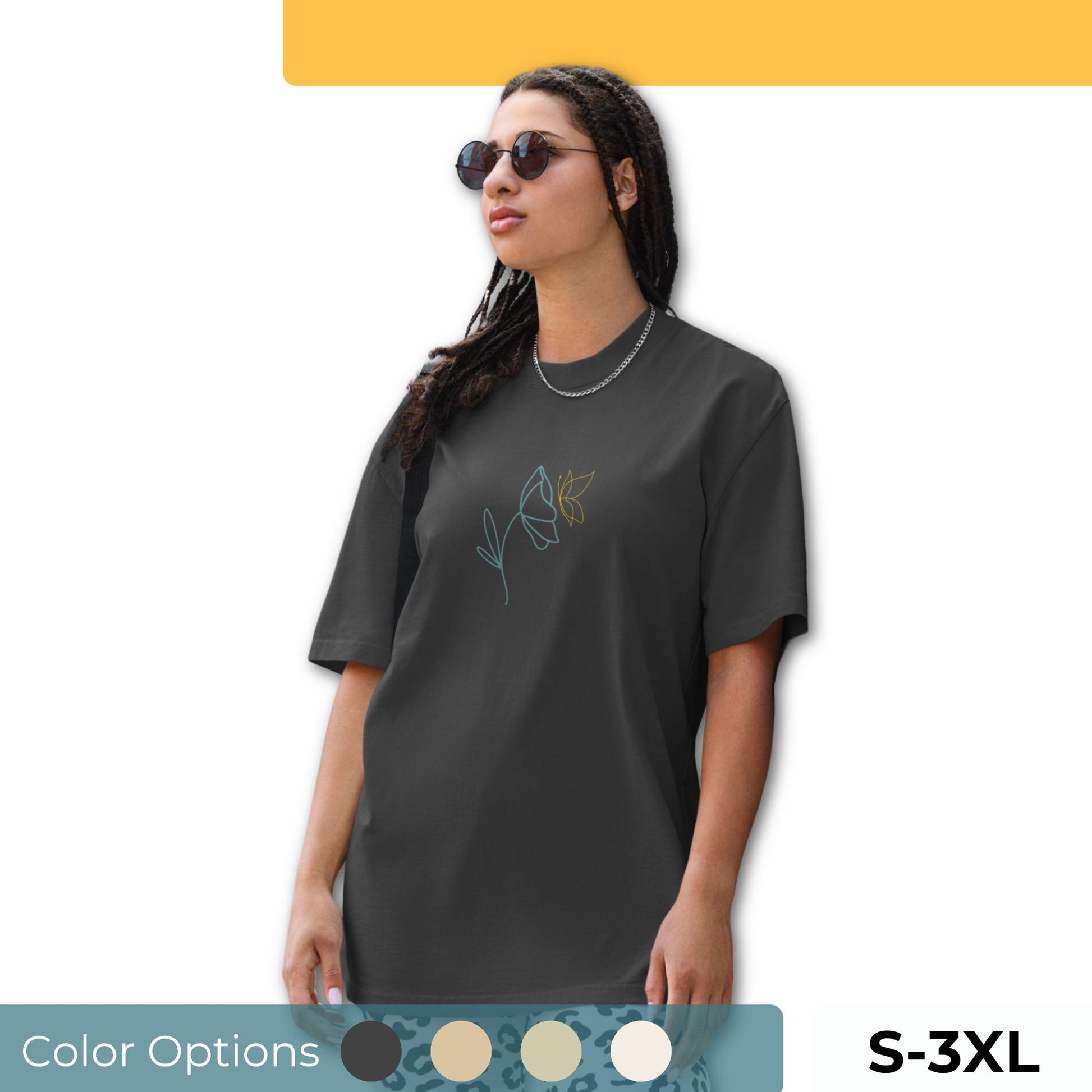 Woman wearing an oversized faded tee with a minimalist floral line art design, highlighting unique self-expression and elegant fashion, available in multiple colors and sizes S-3XL.