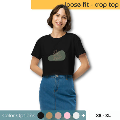 Woman wearing a loose-fit crop top with a floral coffee cup graphic design, embodying comfortable and authentic fashion by BYOL.