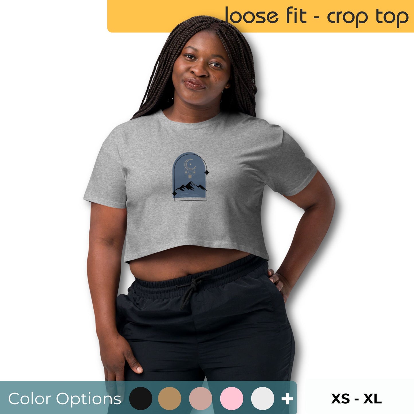 Woman wearing a loose-fit crop top with a tranquil night sky graphic design, representing comfortable and authentic fashion by BYOL. Available in multiple color options and in sizes xs-xl