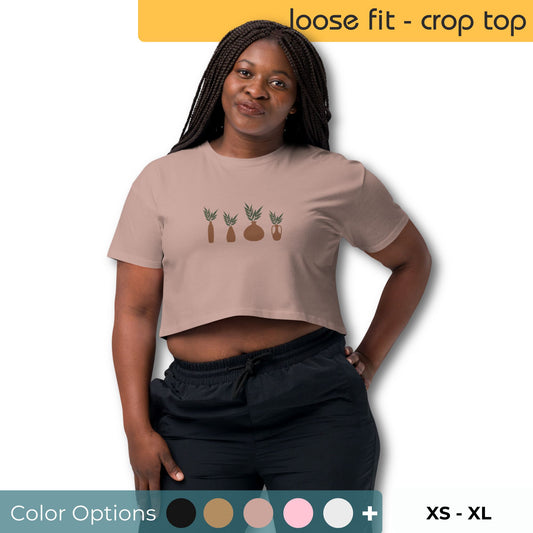 Woman wearing a loose-fit crop top with a charming pineapple graphic design, representing comfortable and authentic fashion by BYOL. Multiple color options and xs-xl available