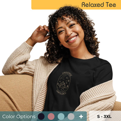 Smiling woman with curly hair wearing a relaxed fit tee in black with 'Universe Unfolded' graphic design, available in various colors, sizes S-3XL