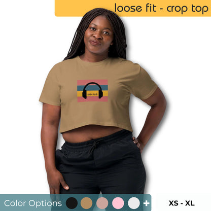 Woman wearing a taupe loose-fit crop top with a retro headphone graphic, available in sizes XS to XL.