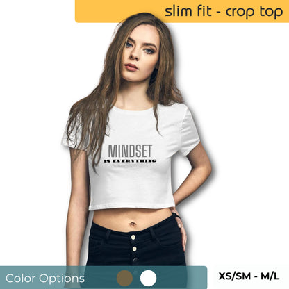 Woman wearing a slim fit white crop top with "Mindset is Everything" print, available in XS/SM - M/L sizes, showcasing available color options.