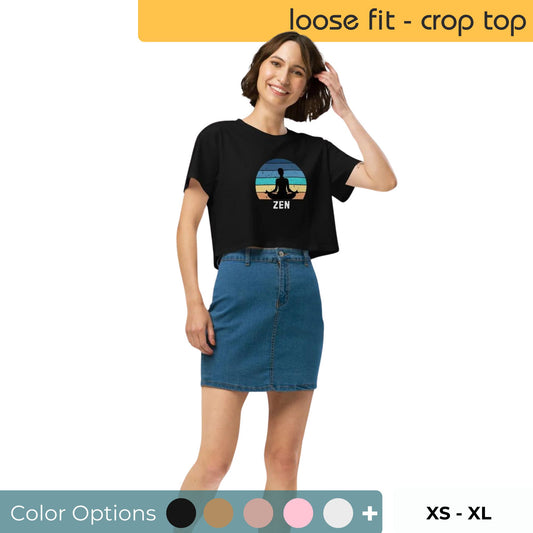 Smiling woman wearing a black Zen graphic crop top with color and size options displayed, paired with a blue denim skirt.