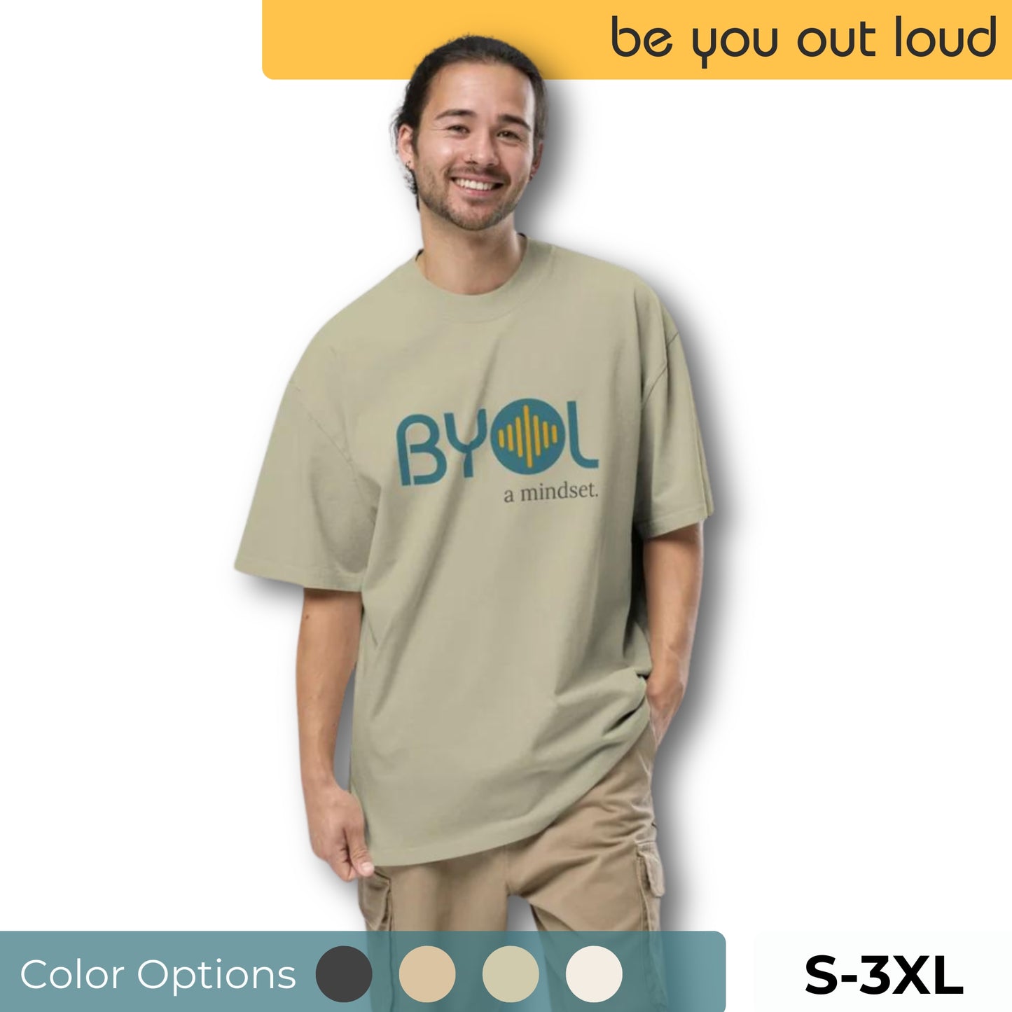 A young man wearing a beige "BYOL: a mindset" T-shirt, smiling and standing with one hand in his pocket. The shirt is available in various colors (dark gray, beige, light blue) and sizes (S-3XL). The "be you out loud" logo is displayed at the top.