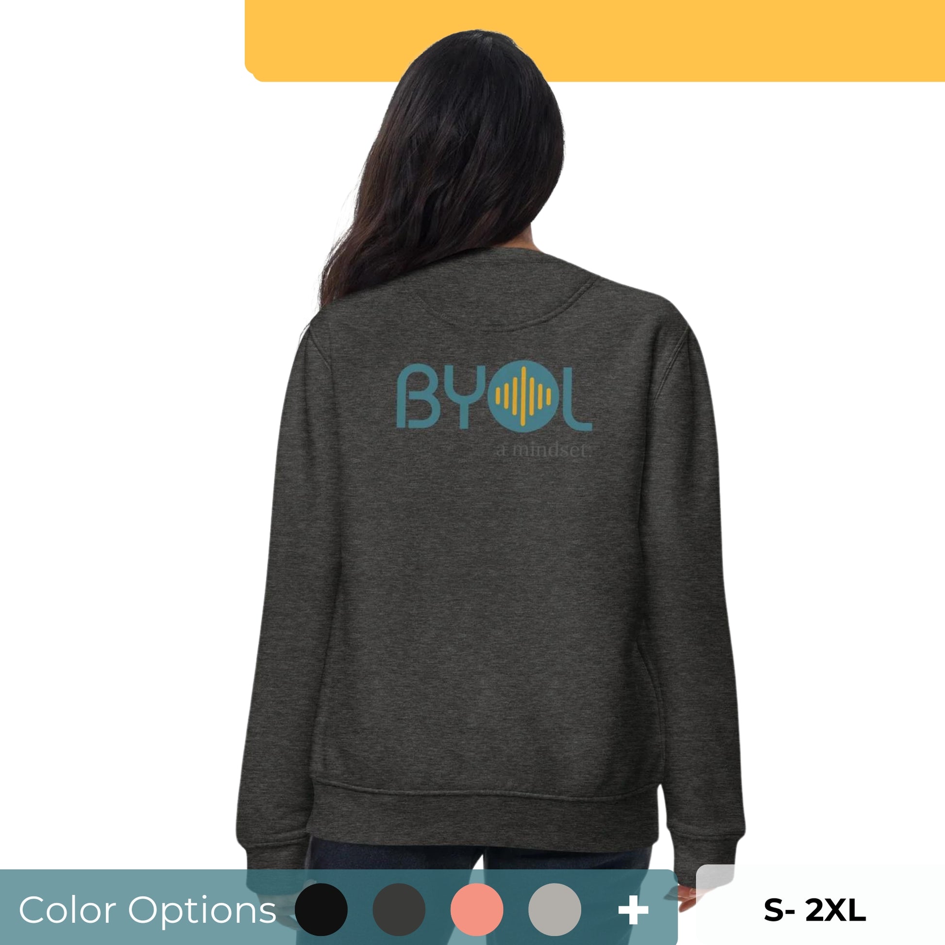 Back view of a woman wearing a charcoal gray BYOL mindset sweatshirt with color options in black, dark gray, pink, and light gray, available in sizes S to 2XL.