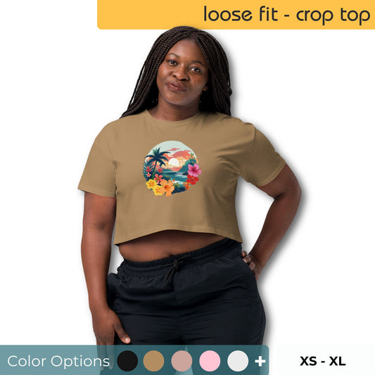 Confident woman posing in a taupe loose-fit crop top with a vibrant tropical beach graphic, complemented by a selection of color swatches and a range of available sizes from XS to XL.