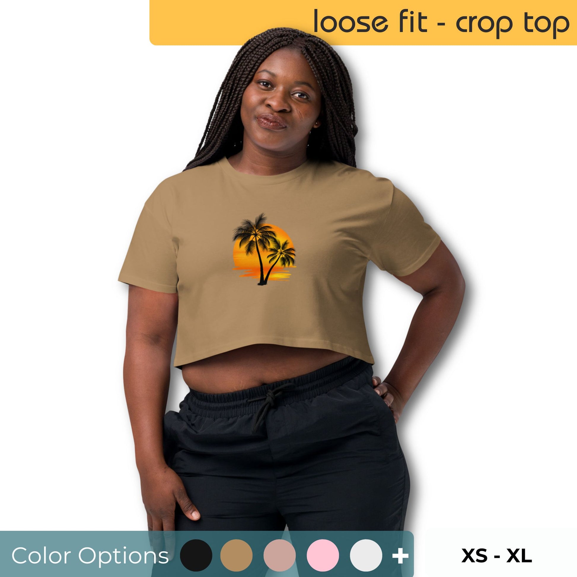 Woman with a confident stance wearing a loose-fit tan crop top with a vibrant palm tree and sunset graphic, paired with black pants, against a backdrop showing color options and sizes XS to XL.