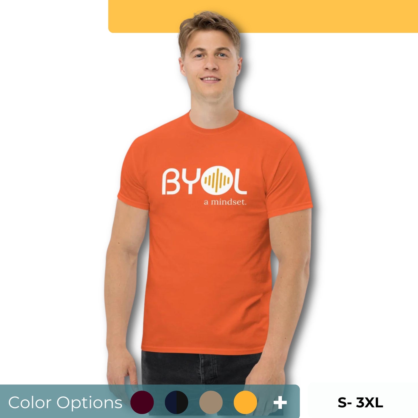 A young man with short blonde hair wearing an orange "BYOL: a mindset" T-shirt, smiling and standing with his arms at his sides. The T-shirt features the "BYOL" logo in white and yellow on the front and is available in multiple colors (maroon, black, brown, gold, plus more) and sizes (S-3XL). The "be you out loud" logo is displayed at the top.