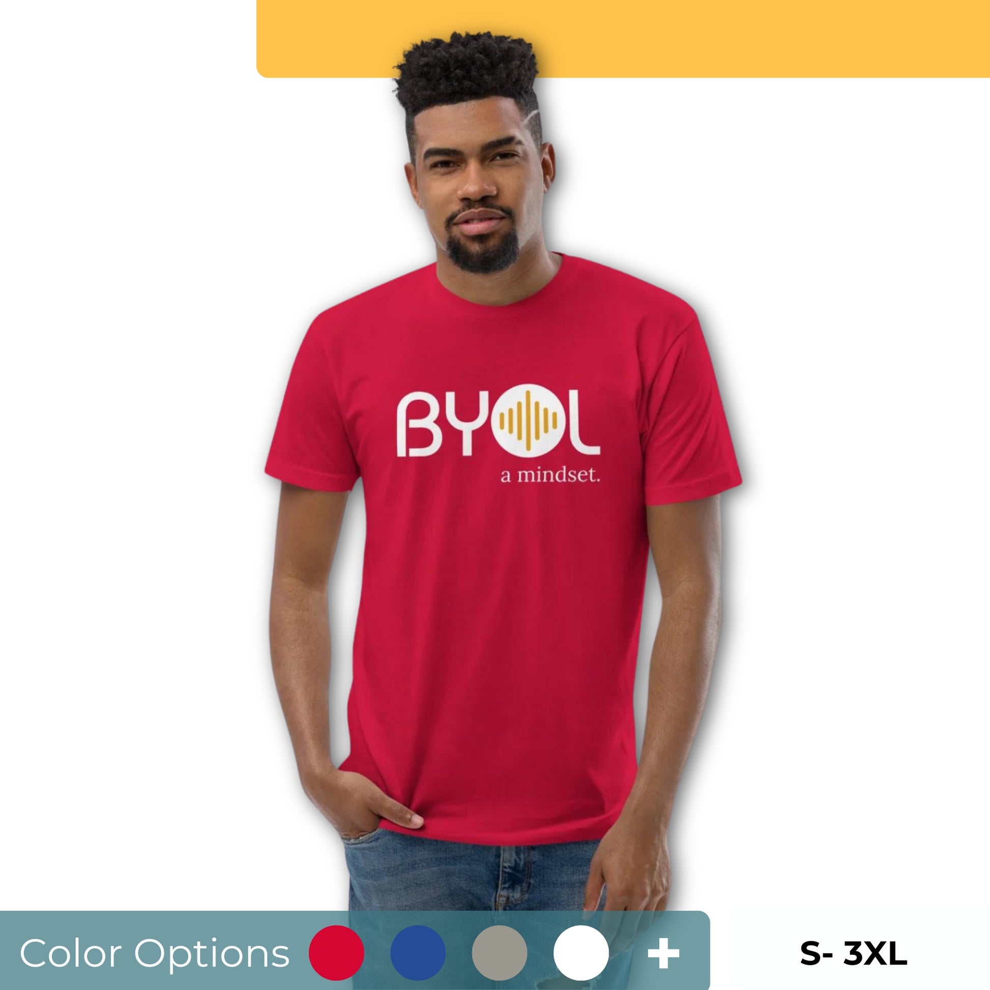 A young man with short curly hair wearing a red "BYOL: a mindset" T-shirt, standing with one hand in his pocket. The T-shirt features the "BYOL" logo in white and yellow on the front and is available in multiple colors (red, blue, gray, white, plus more) and sizes (S-3XL). The "be you out loud" logo is displayed at the top.